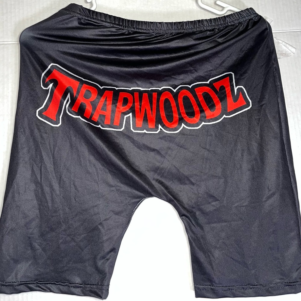 Black biker shorts with “Trapwoodz” on the back